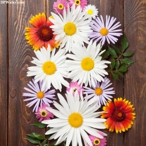 a bunch of flowers on a wooden surface