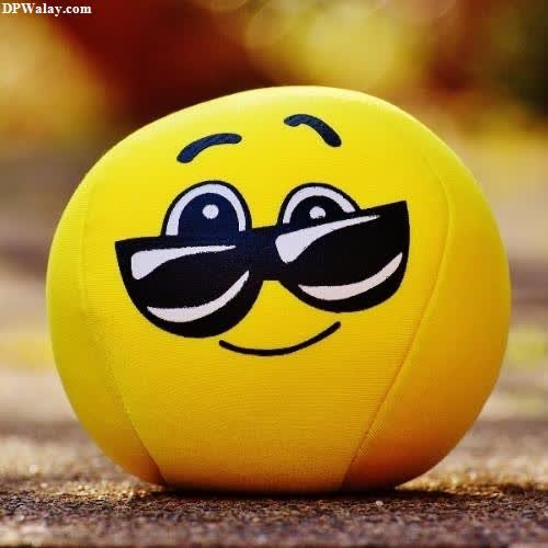 a yellow ball with sunglasses on it