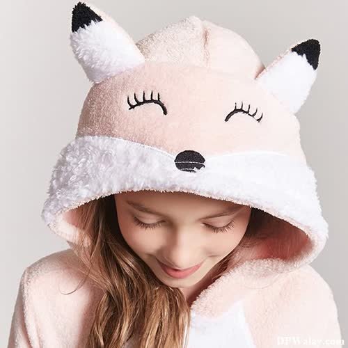 a little girl wearing a pink fox hoodie