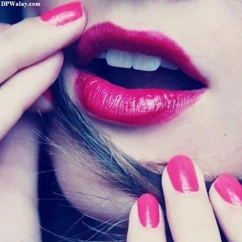 a woman with red lipstick and nails