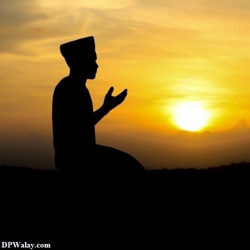 silhouette of a man praying at sunset