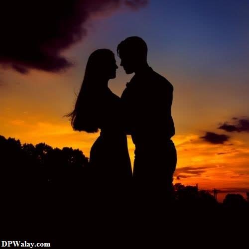 a silhouette of a couple kissing at sunset 