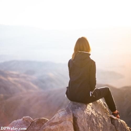 mood off dp - a woman sitting on top of a mountain looking out at the mountains