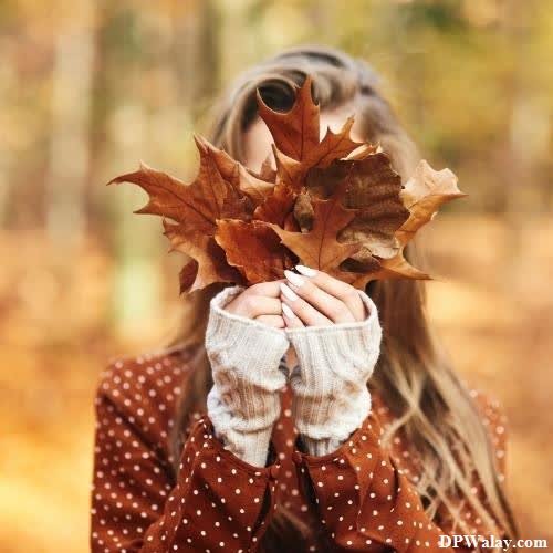 a girl holding a leaf in her hands photos for girl dp