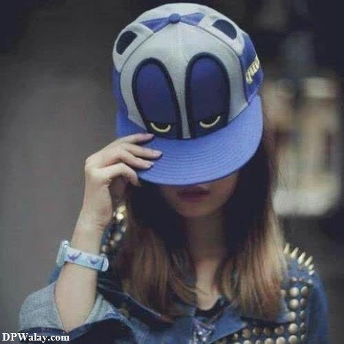 a girl wearing a blue hat with a spider face on it pic for dp girl