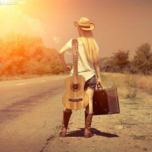 a woman with a guitar and suitcase standing on the side of a road images by DPwalay