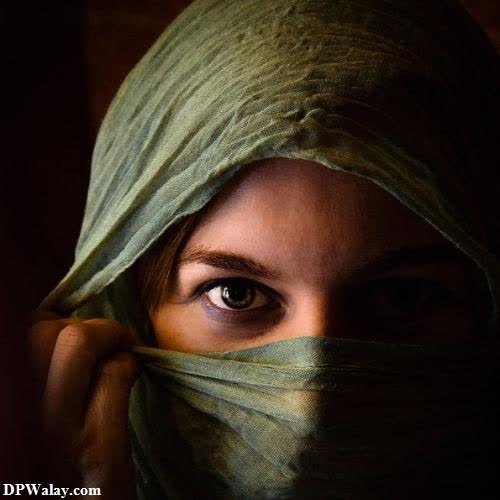 a woman with a green scarf covering her face images by DPwalay