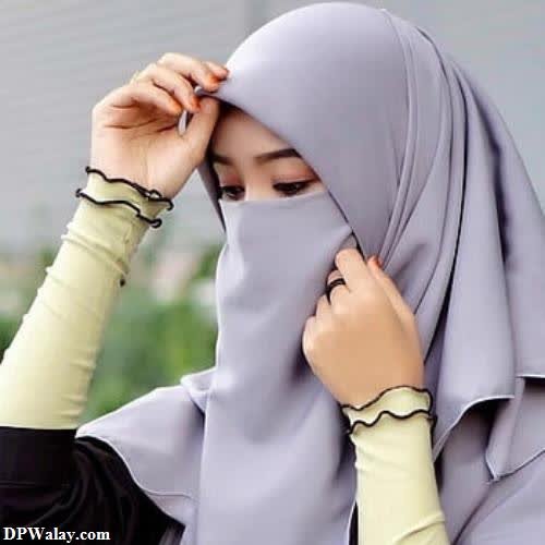 a woman wearing a hina in a gray hina