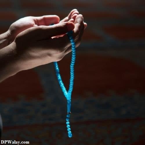 a person holding a rosary in their hand images by DPwalay