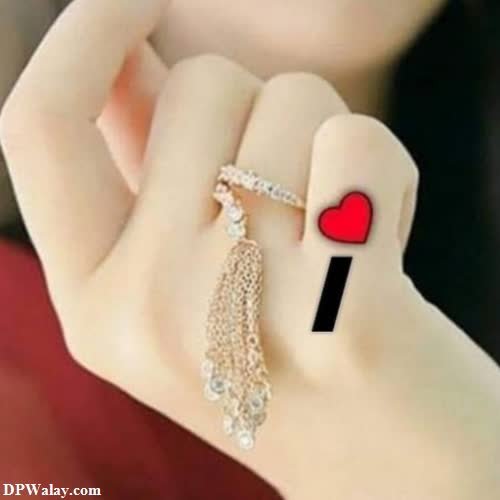 a woman with a red heart ring on her finger images by DPwalay