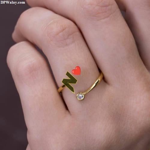 a woman's hand with a ring with a heart and arrow images by DPwalay