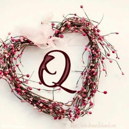 a heart shaped wreath with the letter q on it
