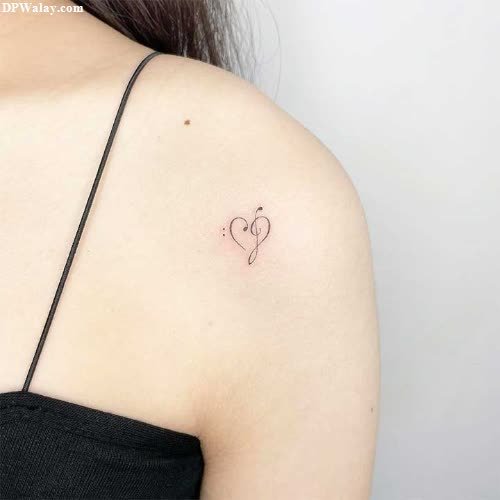 a woman with a small heart tattoo on her shoulder q name dp
