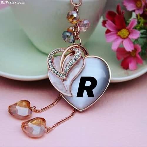 a heart shaped necklace with a pink flower r dp