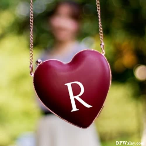 a heart shaped necklace with the letter r hanging from it images by DPwalay