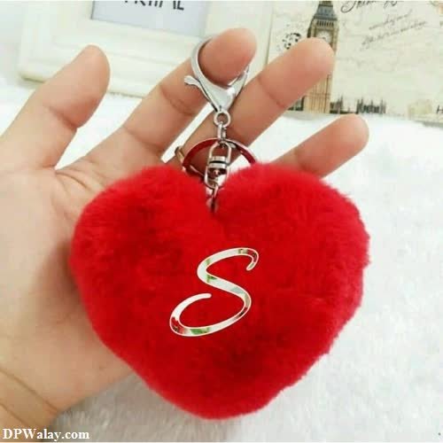 a red heart shaped keychai with a silver ring
