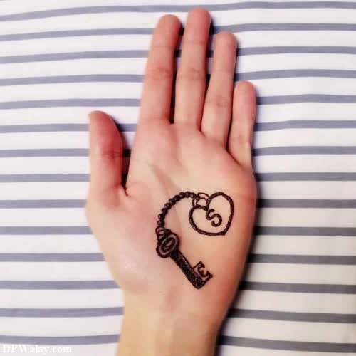 a woman's hand with a tattoo on it-WGFJ