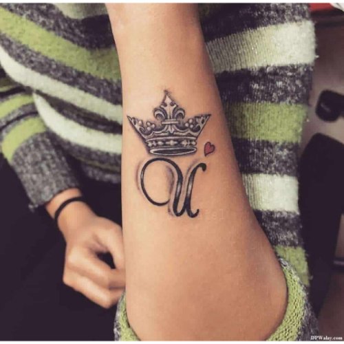 a woman with a crown tattoo on her wrist 