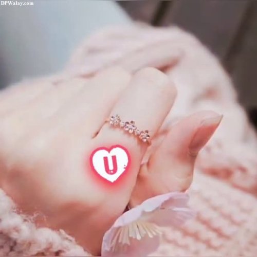 a person holding a ring with a heart on it