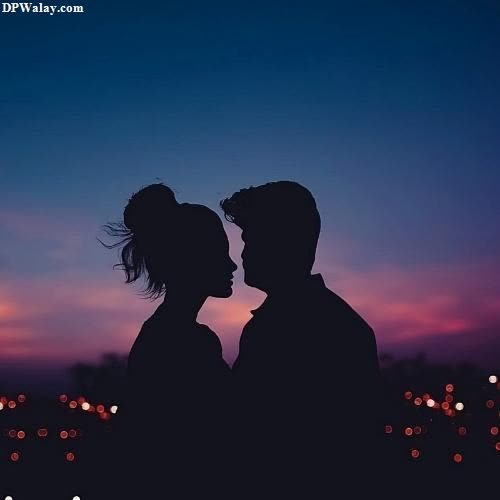 a couple kissing at sunset